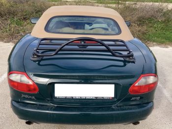 Green jaguar xk8 convertible with a black luggage rack fitted
