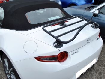 mx5 luggage rack black on white mx5 nd photographed close from the side in a car park