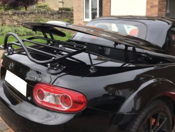 Black Mazda MX5 roadster coupe with a revo-rack luggage rack fitted and the roof operating